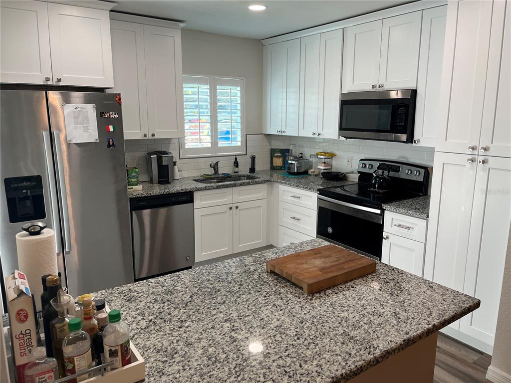 2254 Norwegian Drive, Unit 6 Clearwater, FL 33763 - Photo 11 of 56 a kitchen with a sink stove and refrigerator