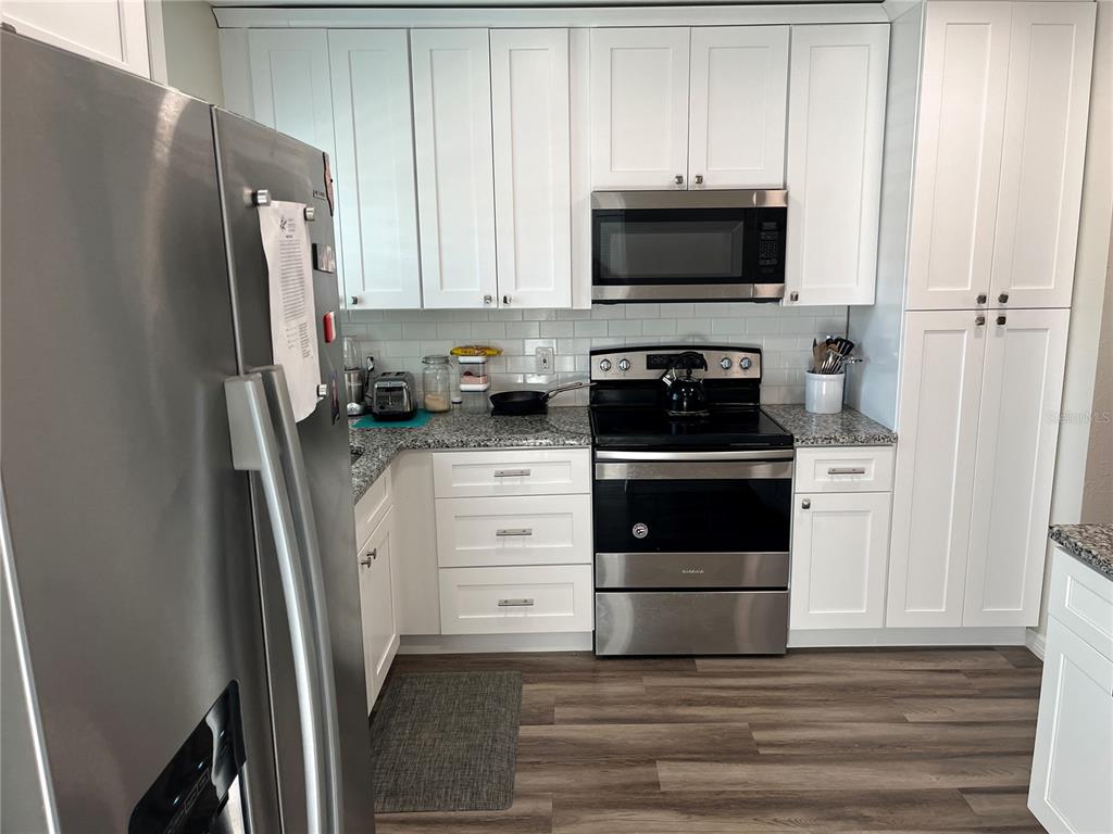 2254 Norwegian Drive, Unit 6 Clearwater, FL 33763 - Photo 12 of 56 a kitchen with a refrigerator stove and microwave