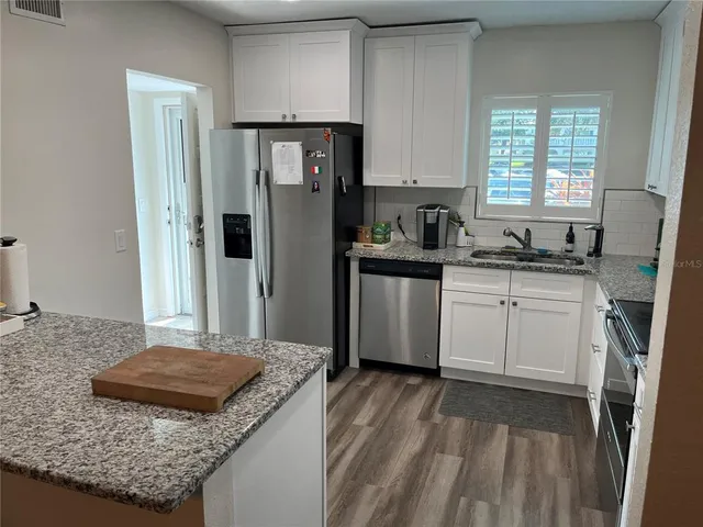 a kitchen with a sink stove and refrigerator