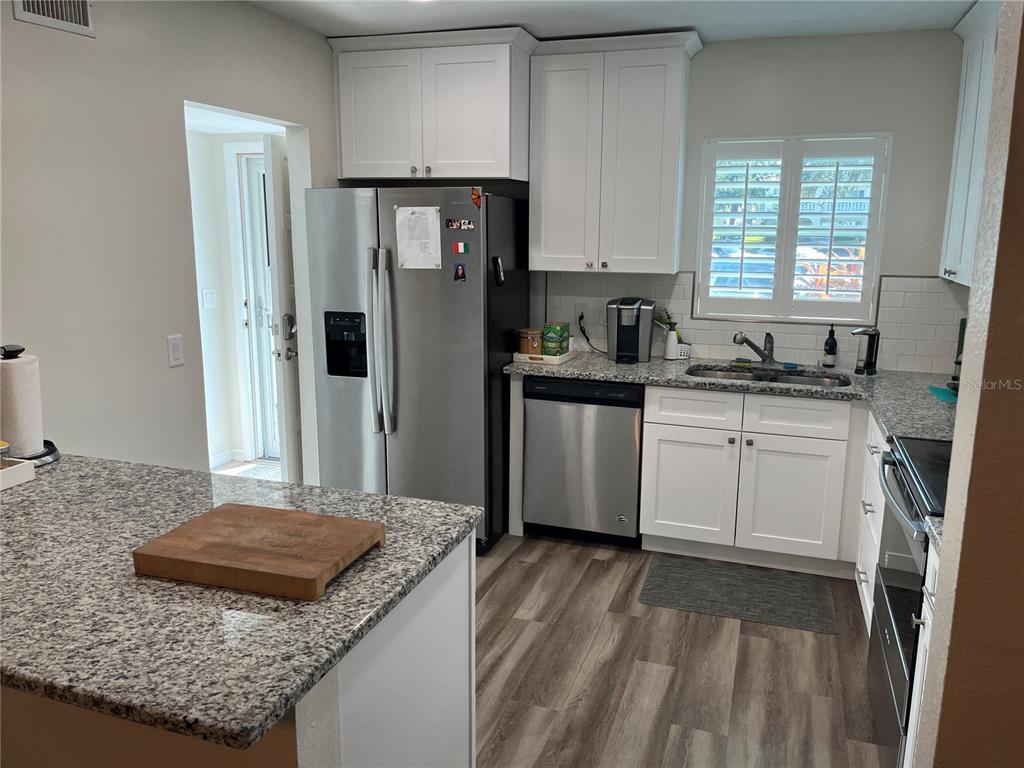 2254 Norwegian Drive, Unit 6 Clearwater, FL 33763 - Photo 13 of 56 a kitchen with a sink stove and refrigerator
