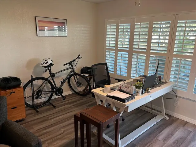 a view of a workspace with furniture and a window