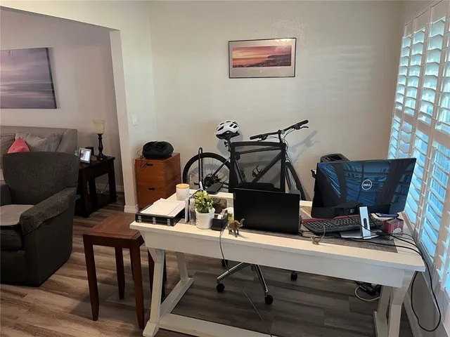 a view of workspace with wooden floor windows