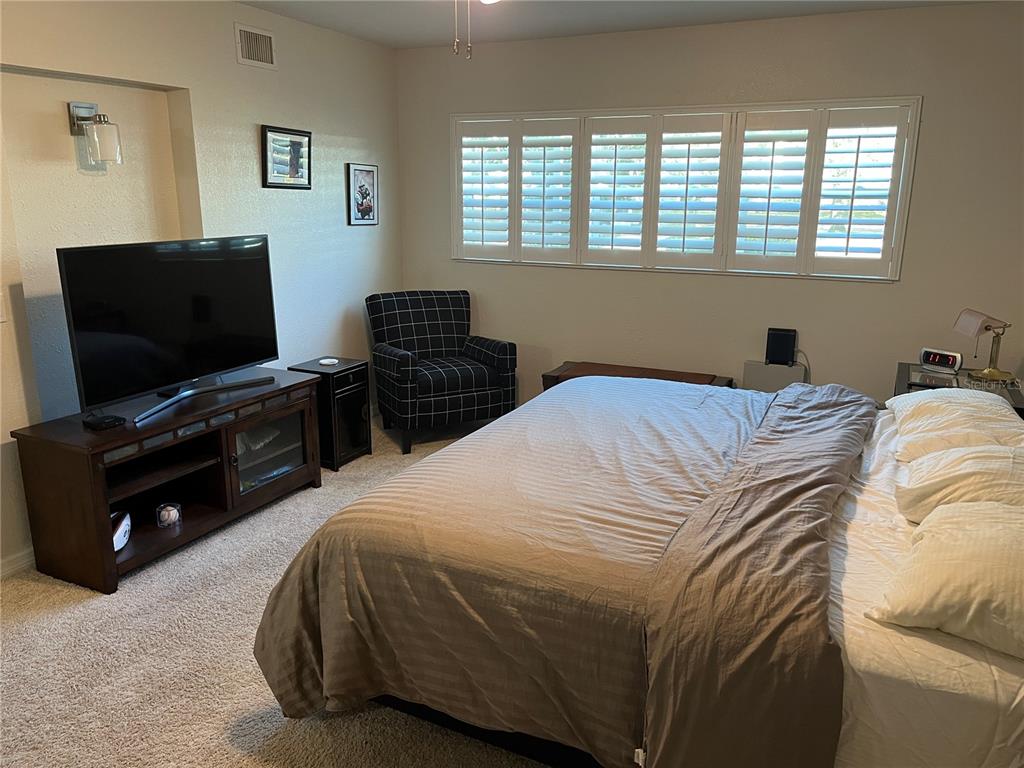 2254 Norwegian Drive, Unit 6 Clearwater, FL 33763 - Photo 18 of 56 a bedroom with a bed and a flat screen tv