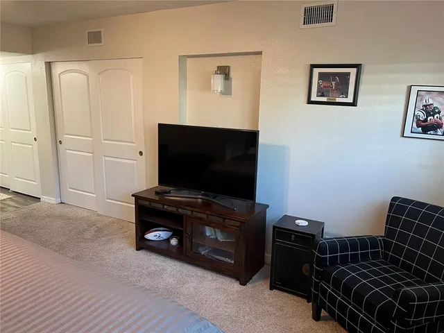 a living room with furniture and flat screen tv