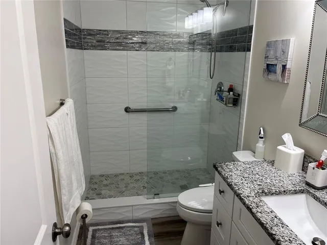 a bathroom with a toilet and a mirror
