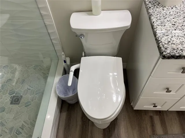 a large bed sitting in a bedroom next to a window