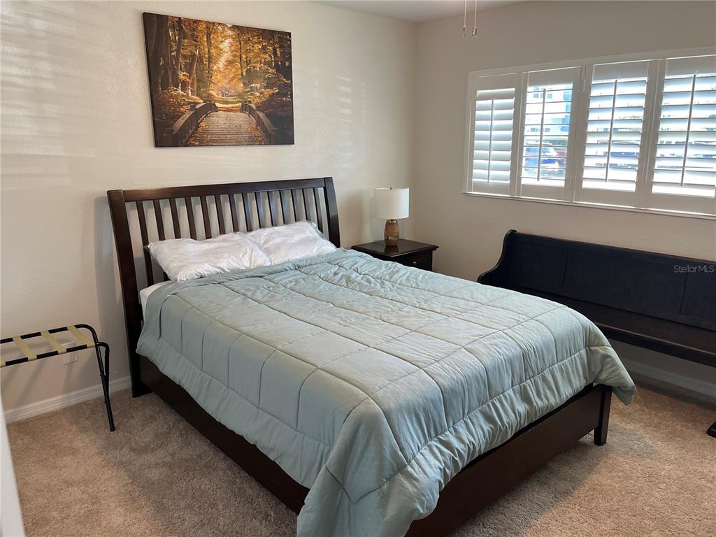 2254 Norwegian Drive, Unit 6 Clearwater, FL 33763 - Photo 25 of 56 a large bed sitting in a bedroom next to a window