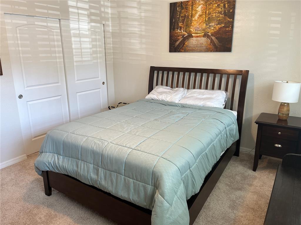 2254 Norwegian Drive, Unit 6 Clearwater, FL 33763 - Photo 26 of 56 a bedroom with a bed and painting on the wall