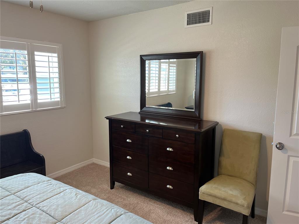 2254 Norwegian Drive, Unit 6 Clearwater, FL 33763 - Photo 27 of 56 a bedroom with a bed and a window