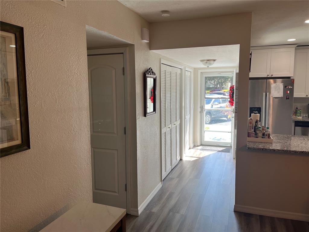2254 Norwegian Drive, Unit 6 Clearwater, FL 33763 - Photo 4 of 56 a hallway with wooden floor and cabinets
