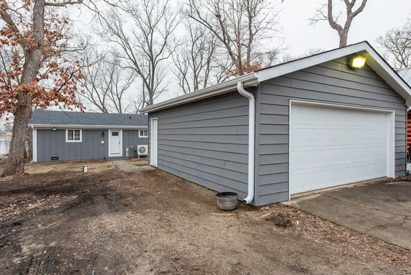 a view of a house with a yard and garage