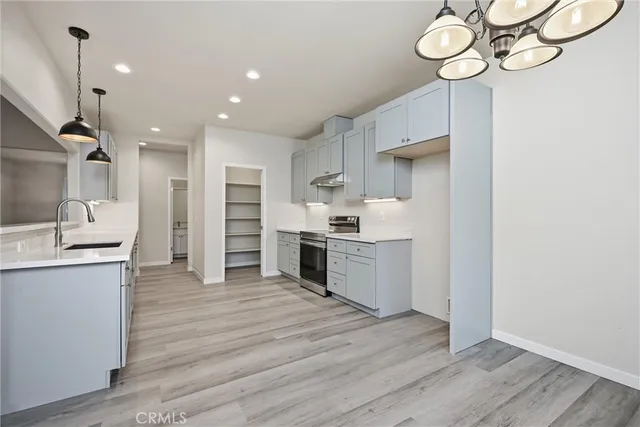 a kitchen with a refrigerator and a sink