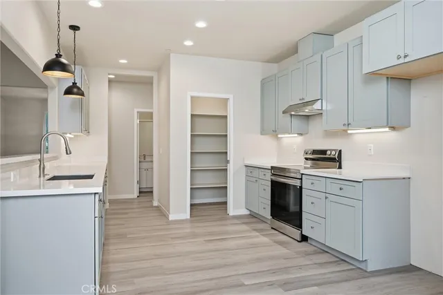 a kitchen with a sink stainless steel appliances and cabinets