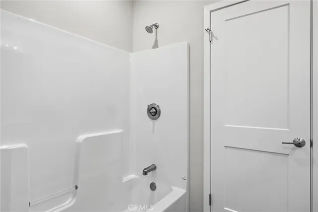 an empty room with wooden floor and a window