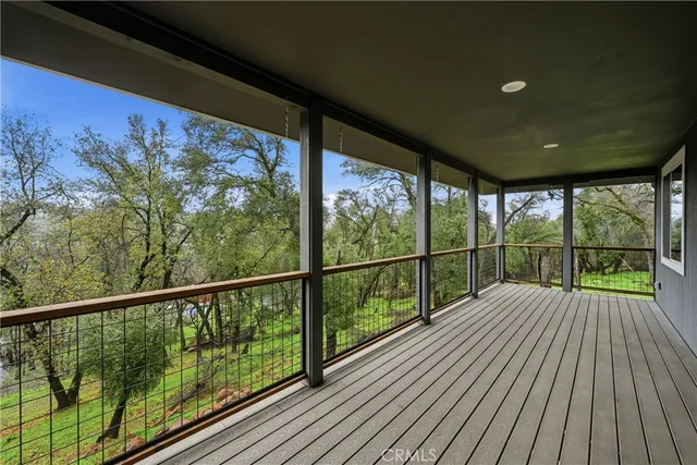 a view of a balcony with wooden floor