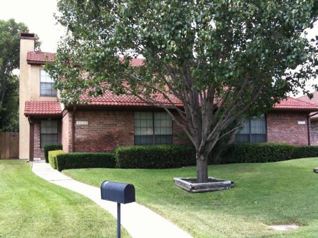 3031 Modella Avenue Dallas, TX 75229 - Photo 1 of 15 View of front of house featuring a chimney, a tile roof, brick siding, and a front lawn