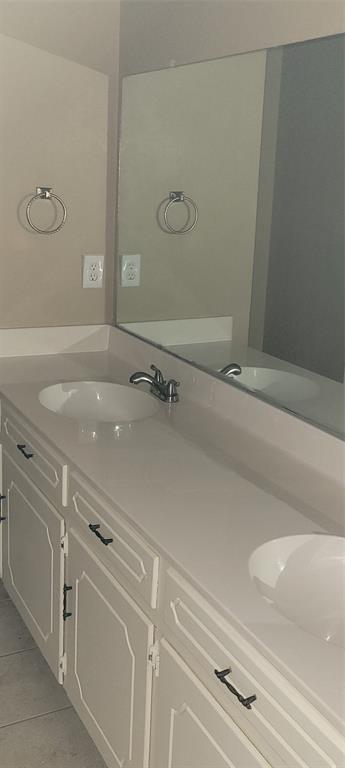 3031 Modella Avenue Dallas, TX 75229 - Photo 13 of 15 Bathroom featuring double vanity and light tile patterned flooring
