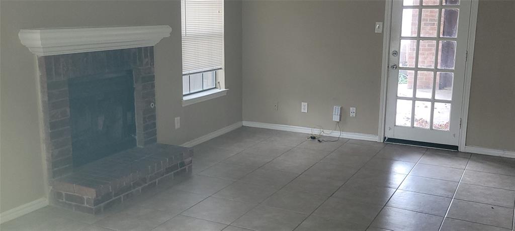 3031 Modella Avenue Dallas, TX 75229 - Photo 15 of 15 Unfurnished living room featuring baseboards and tile patterned floors