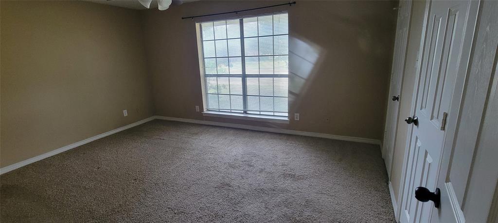 3031 Modella Avenue Dallas, TX 75229 - Photo 4 of 15 Spare room with light colored carpet and baseboards
