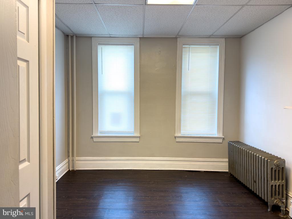 658 Walnut Street, Unit 1 Pottstown, PA 19464 - Photo 11 of 19 an empty room with wooden floor and windows
