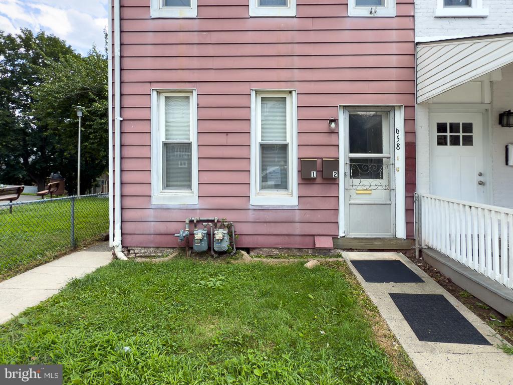 658 Walnut Street, Unit 1 Pottstown, PA 19464 - Photo 17 of 19 a front view of a house with a yard and fence