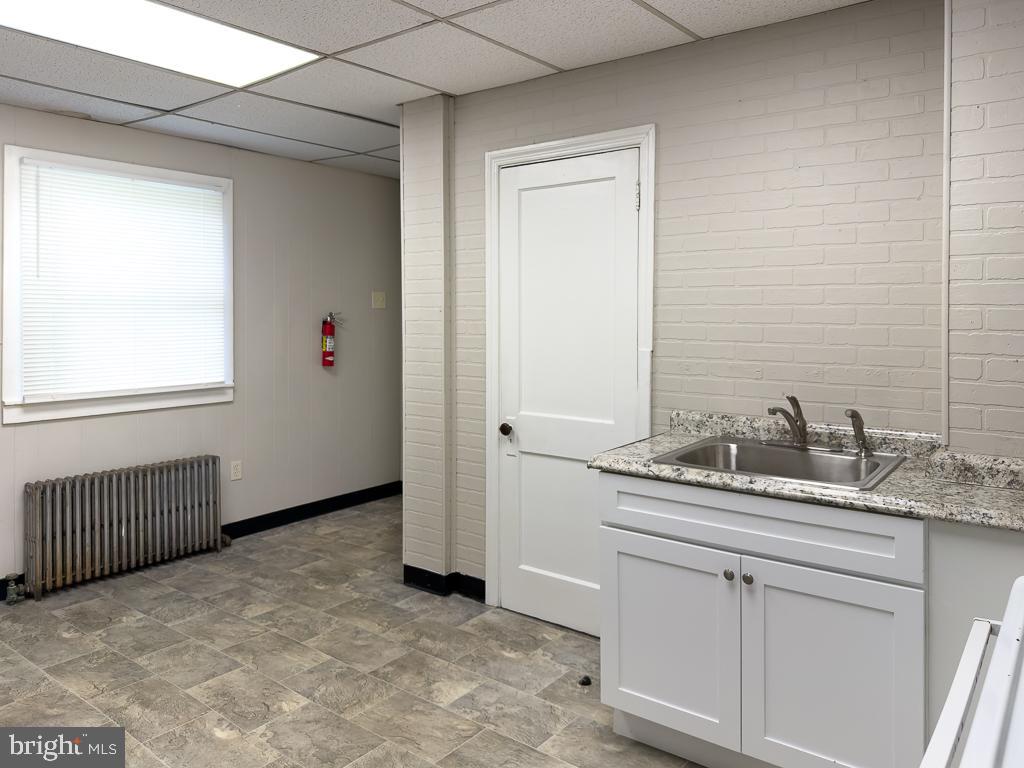 658 Walnut Street, Unit 1 Pottstown, PA 19464 - Photo 2 of 19 a bathroom with a granite countertop sink and a mirror