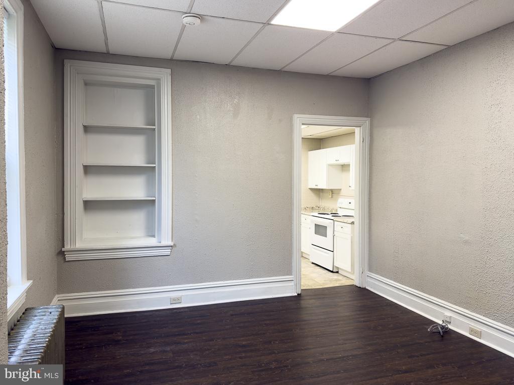 658 Walnut Street, Unit 1 Pottstown, PA 19464 - Photo 9 of 19 a view of an empty room with a window and wooden floor