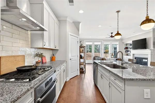 a kitchen with stove a sink and a refrigerator