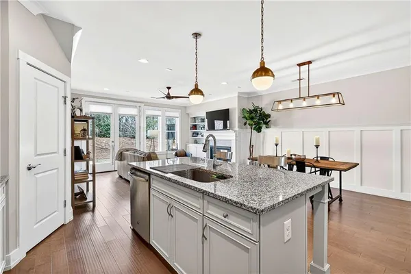 a kitchen with a sink a counter space and wooden floor