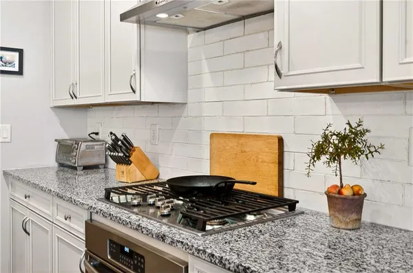a kitchen with a stove and a wooden cabinets