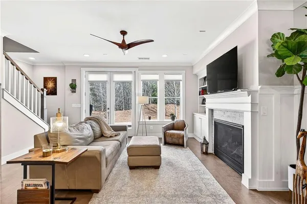 a living room with furniture a fireplace and a flat screen tv
