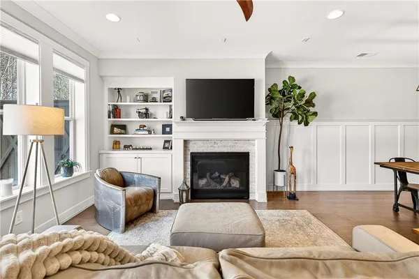 a living room with furniture a fireplace and a flat screen tv