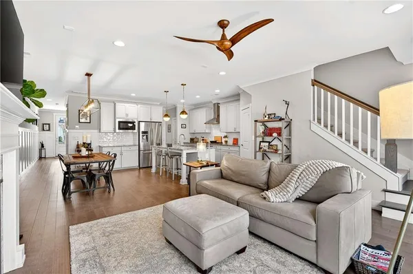 a living room with furniture kitchen view and a dining table