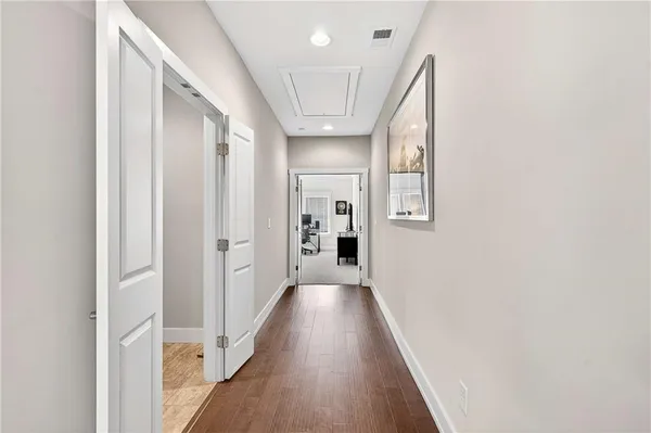 a view of hallway with wooden floor