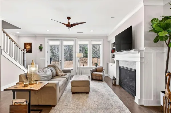 a living room with furniture a fireplace and a flat screen tv