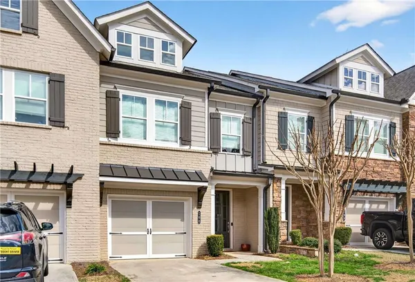 a front view of a residential apartment building with a yard