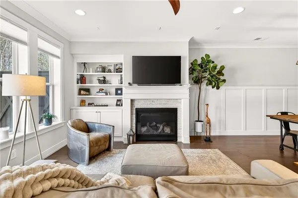 a living room with furniture a fireplace and a flat screen tv