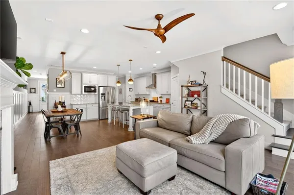 a living room with furniture kitchen view and a dining table