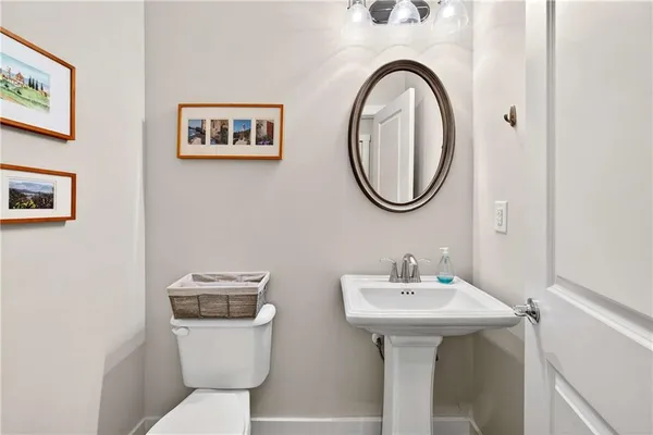 a bathroom with a toilet a sink and a mirror