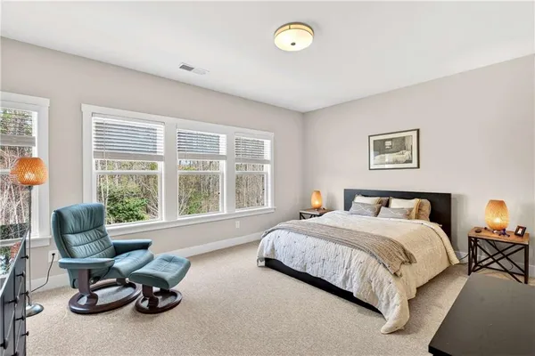 a bedroom with a bed and a chair