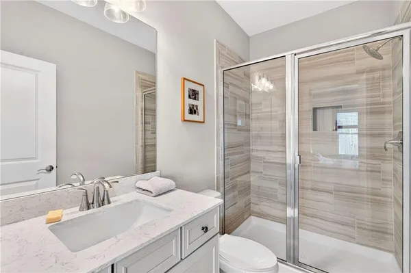 a bathroom with a sink toilet and shower