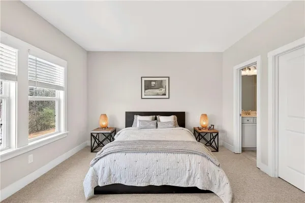 a bedroom with a bed and glass window