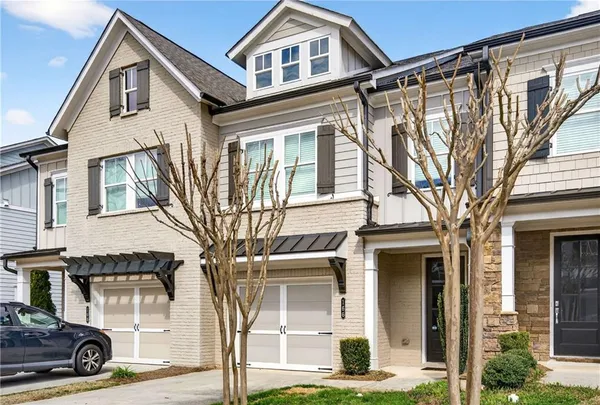 a view of a white house with large windows