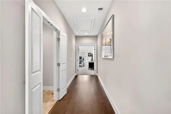 a view of hallway with wooden floor