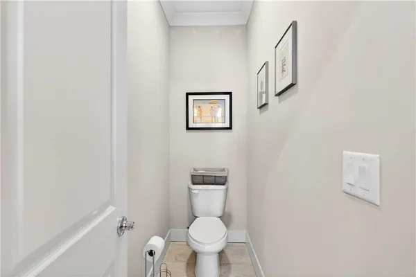a white toilet sitting next to a small bathroom
