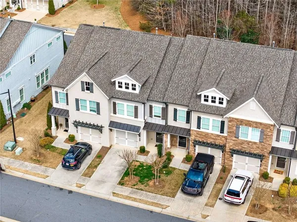 a front view of a building with large windows and a road
