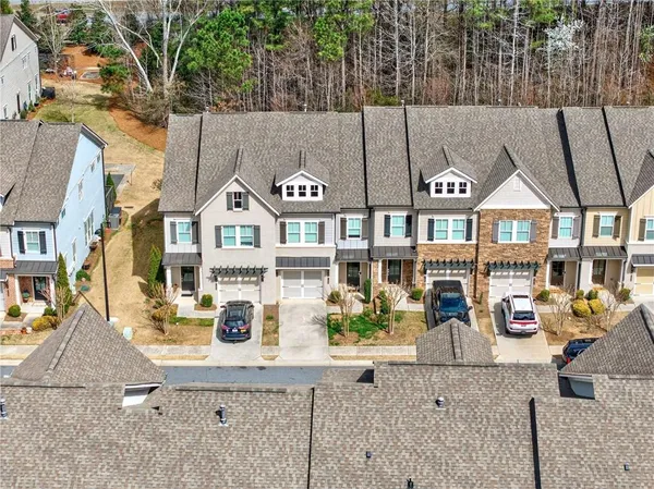 a city view with tall buildings and cars parked