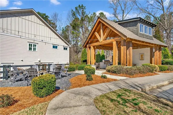a backyard of a house with a large tree