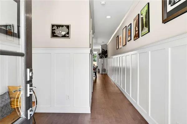 a view of staircase with lots of frames on wall and a potted plant
