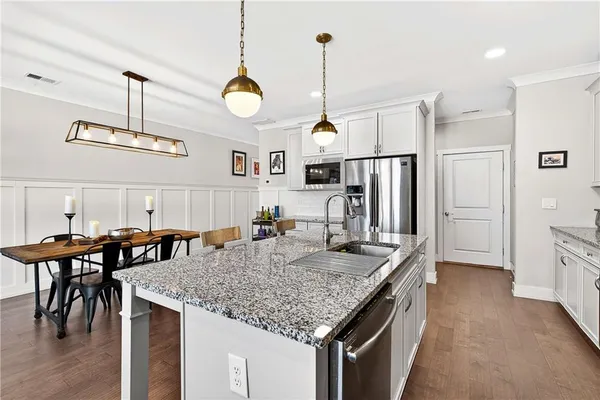 a kitchen with stainless steel appliances granite countertop stove top oven and refrigerator